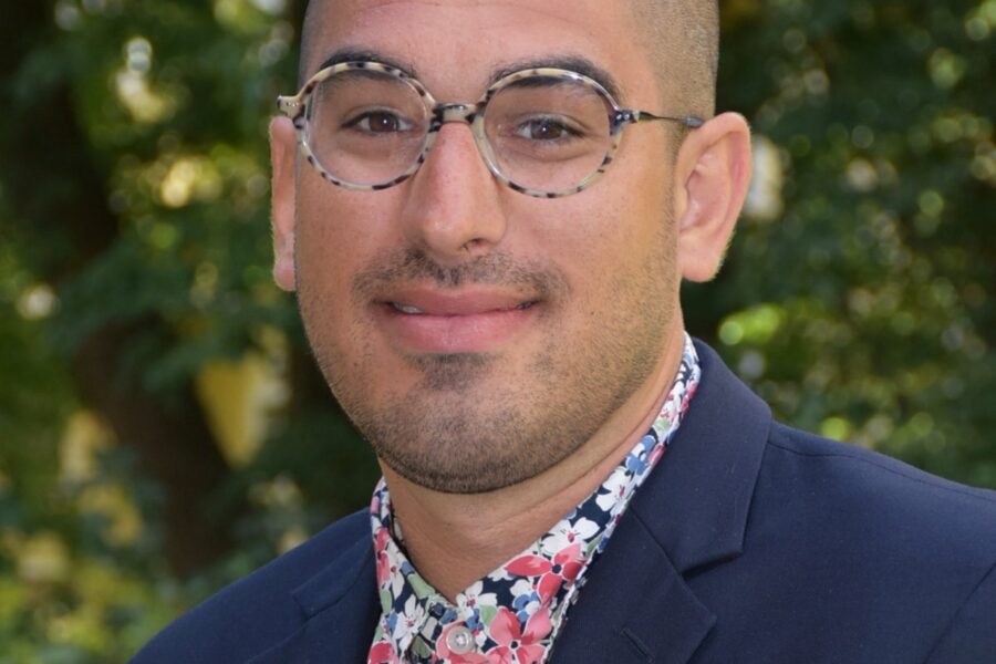 Sam Schreiber, science, sustainability and history teacher at The Pennfield School, smiling for a school portrait.