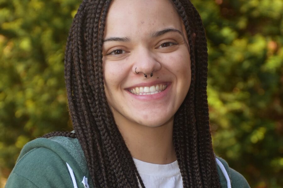 Alexis Gibbs, preschool assistant and theatre teacher at The Pennfield School, smiling in a school portrait.
